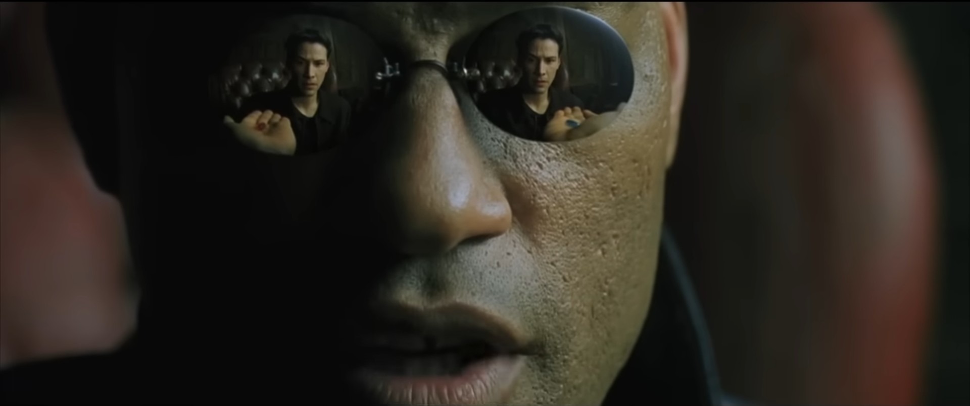 matrix scene with Morpheus offering Neo choice of pill; camera pointing at Morpheus's reflective sunglasses